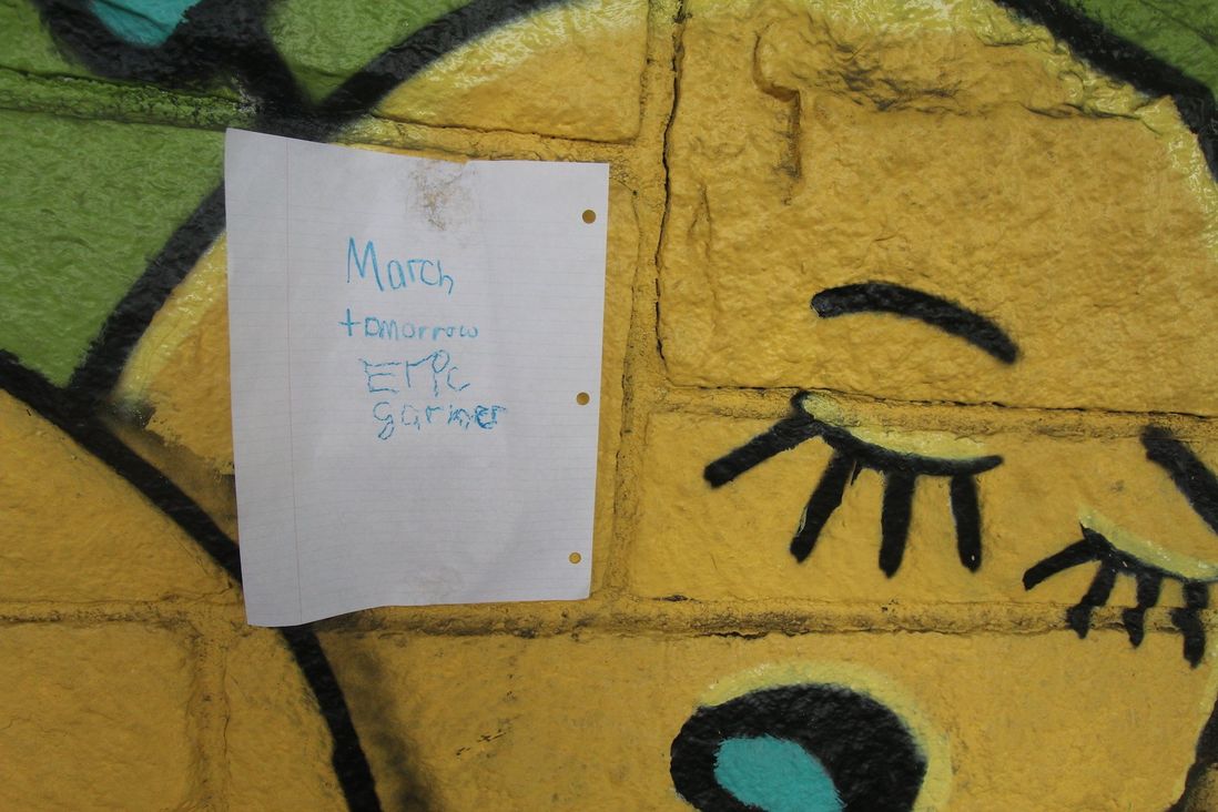 In an underpass from the ferry terminal to the gathering spot for the march, a sign that appeared to be made by a grade school aged child notified the neighborhood of the event.